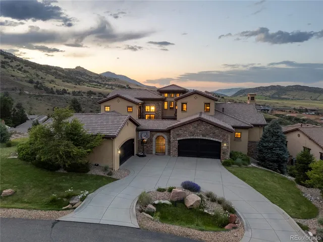 a front view of a house with a garden and plants