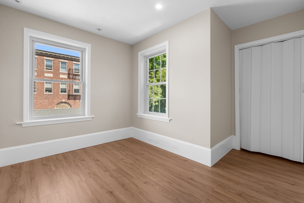 6 Windsor Street Andover, MA 01810 - Photo 13 of 34 a view of an empty room with wooden floor and a window