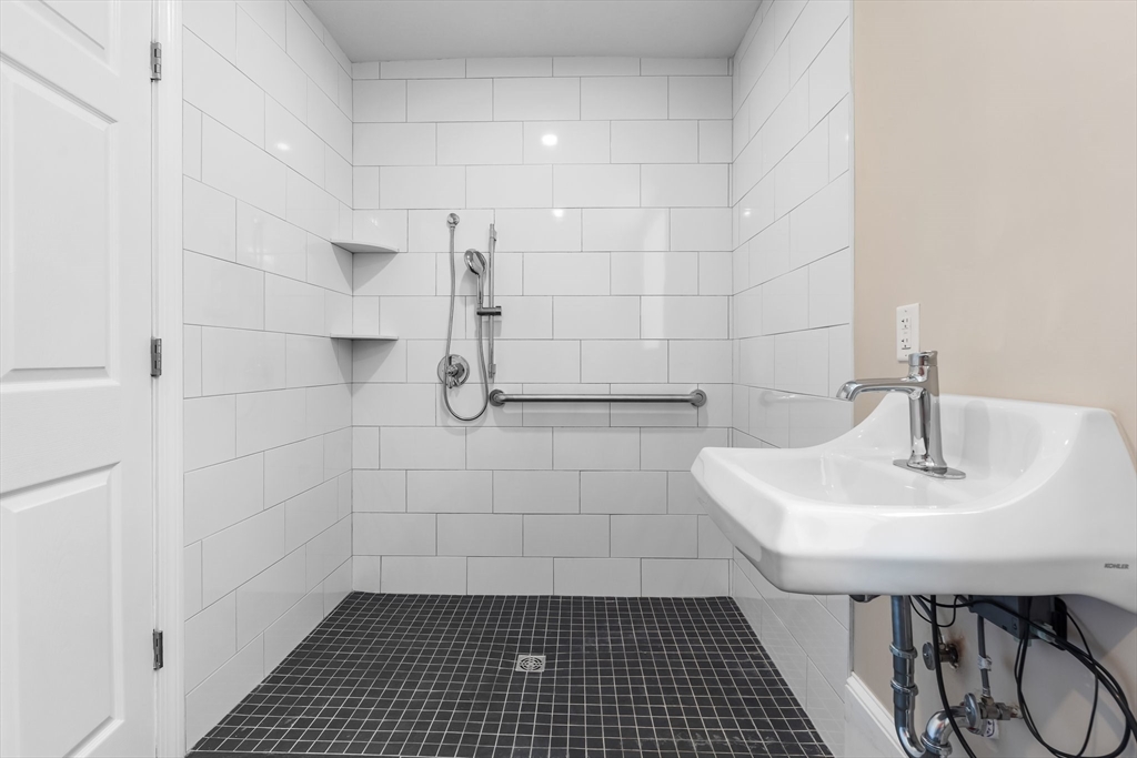 6 Windsor Street Andover, MA 01810 - Photo 17 of 34 a bathroom with a sink shower and a mirror