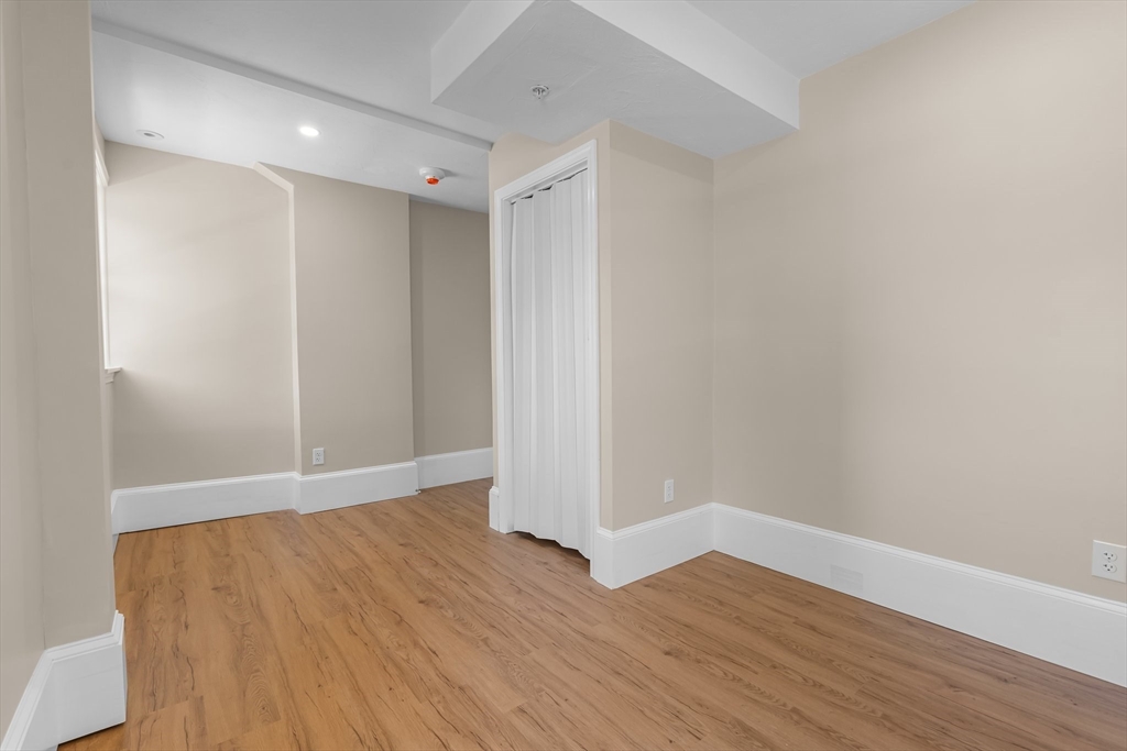 6 Windsor Street Andover, MA 01810 - Photo 20 of 34 a view of an empty room with wooden floor
