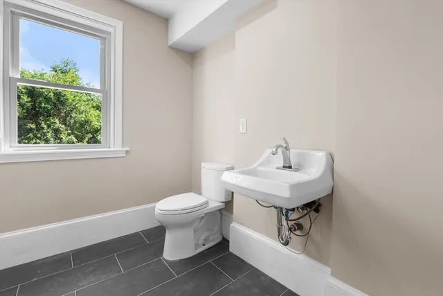 a white toilet sitting next to a bathroom sink