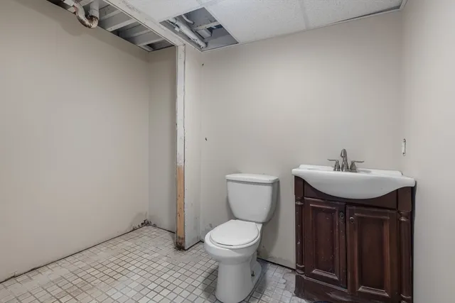 a bathroom with a toilet sink and mirror