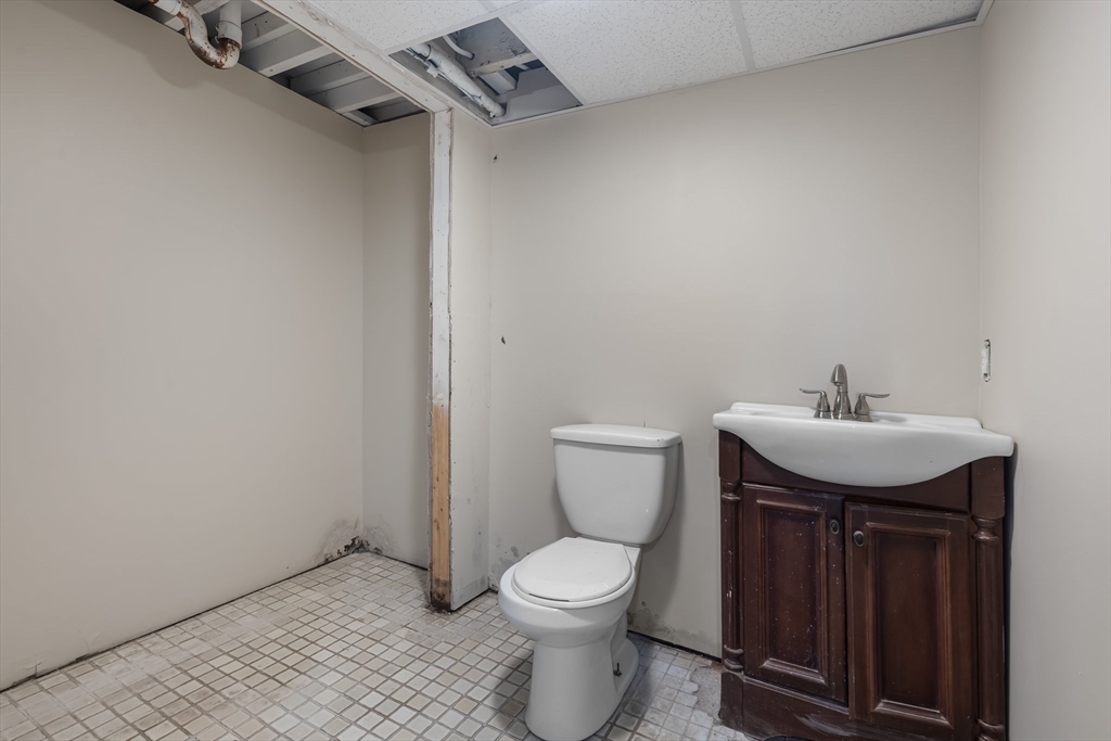 6 Windsor Street Andover, MA 01810 - Photo 31 of 34 a bathroom with a toilet sink and mirror