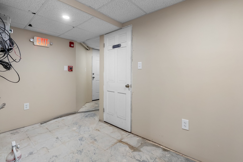 6 Windsor Street Andover, MA 01810 - Photo 32 of 34 a view of a hallway with paintings on the wall