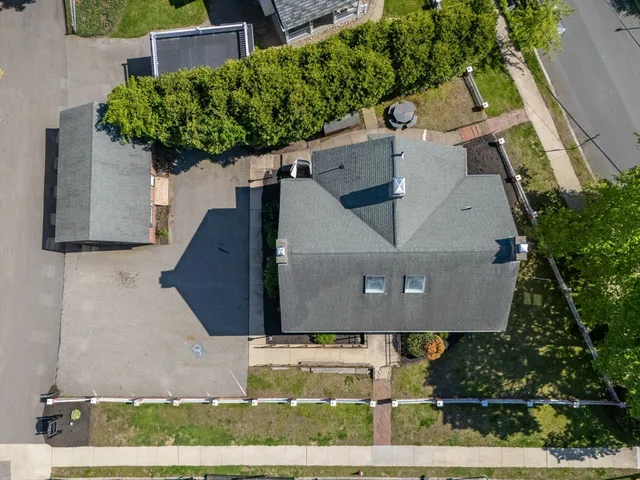 an aerial view of a house with a yard and plants