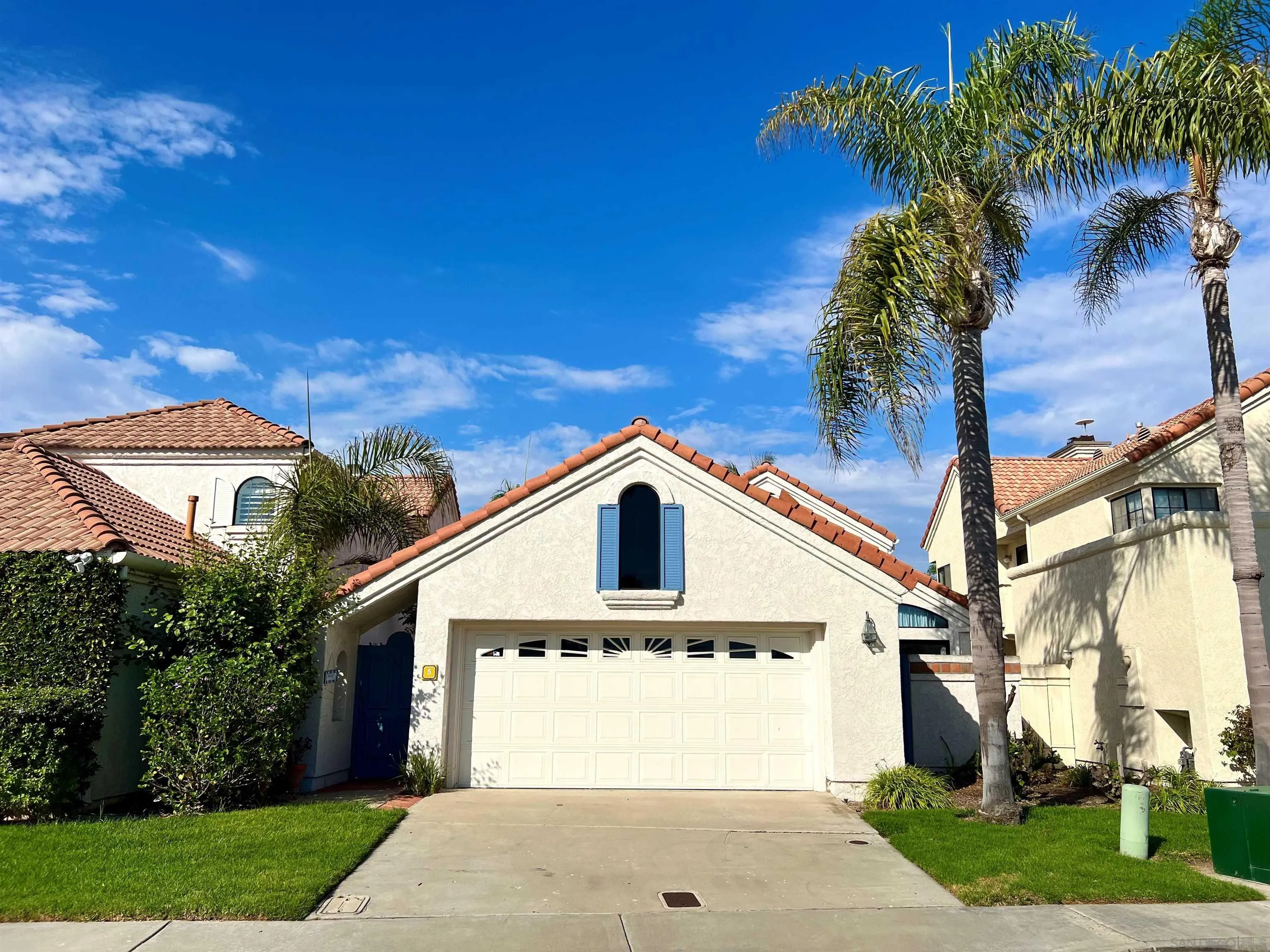 5 Port Royale Road Coronado, CA 92118 - Photo 2 of 2 a front view of a house with a yard and garage
