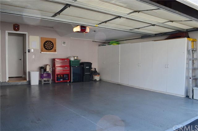613 Rhine Lane Costa Mesa, CA 92626 - Photo 41 of 48 Cabinets, workshop, room for a fridge, epoxy floor.