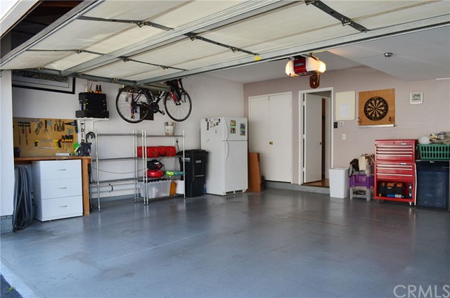 613 Rhine Lane Costa Mesa, CA 92626 - Photo 42 of 48 Cabinets, workshop, room for a fridge, epoxy floor.