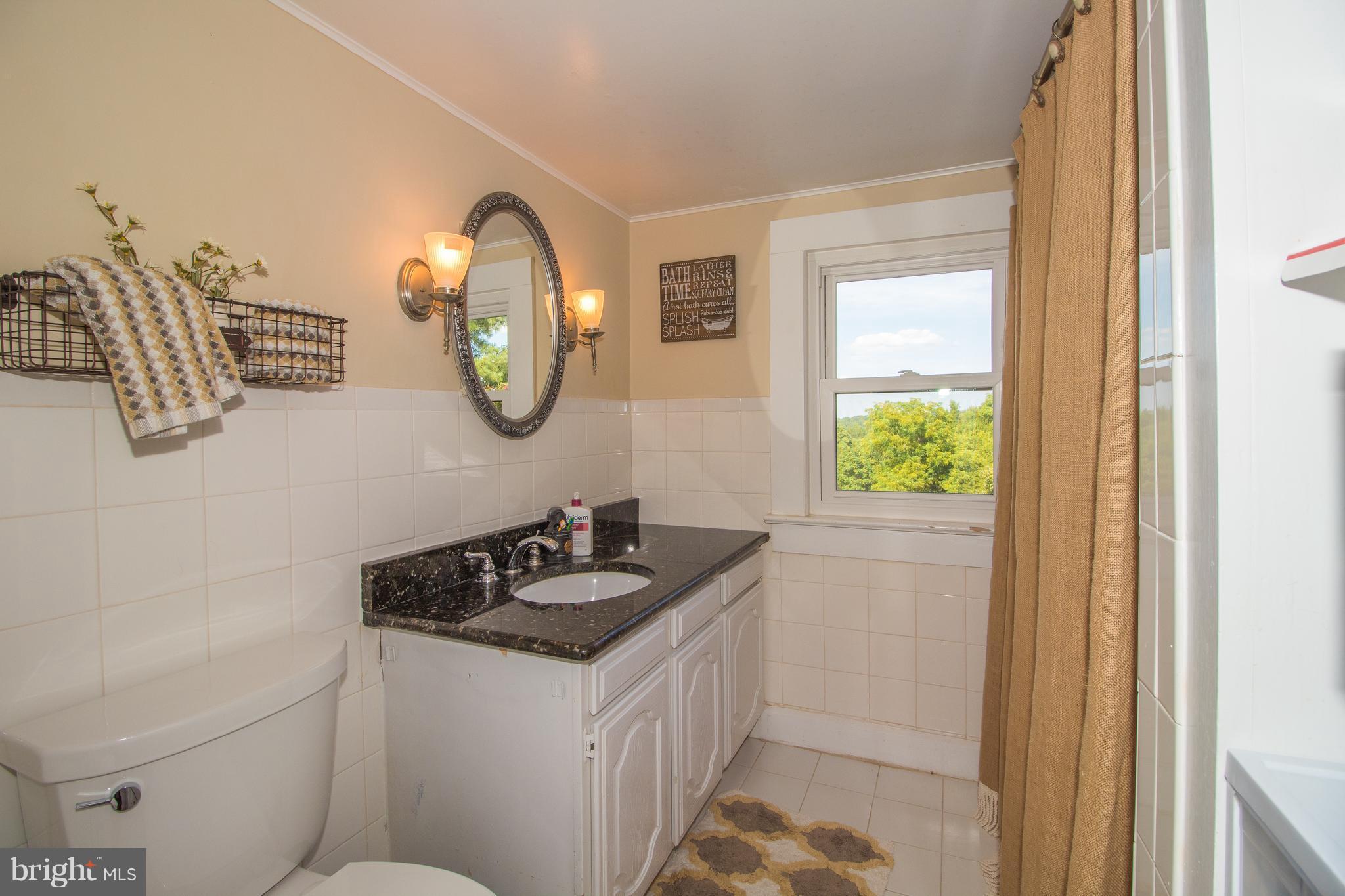 170 Camp Selden Road Fredericksburg, VA 22405 - Photo 15 of 29 a bathroom with a granite countertop sink and a mirror