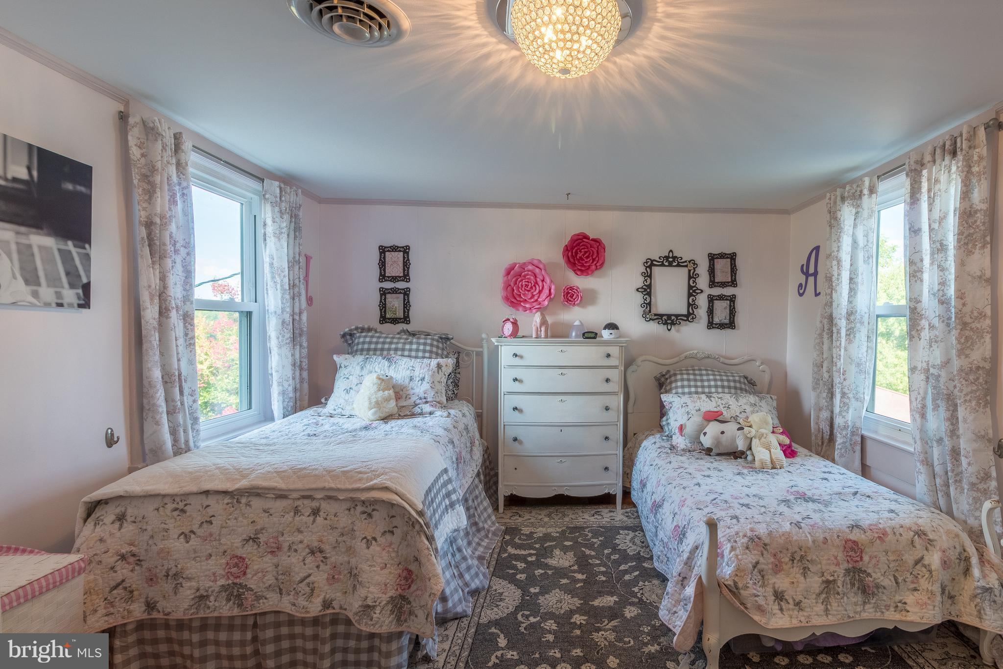 170 Camp Selden Road Fredericksburg, VA 22405 - Photo 16 of 29 a bedroom with a bed and a chandelier