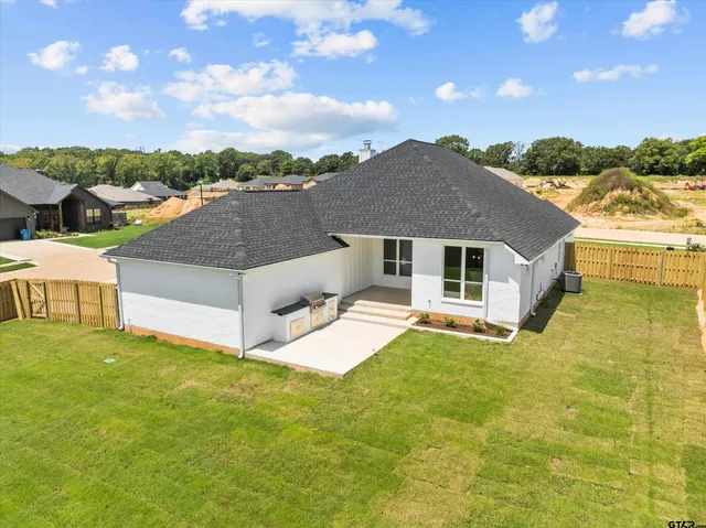 an aerial view of a house with a yard