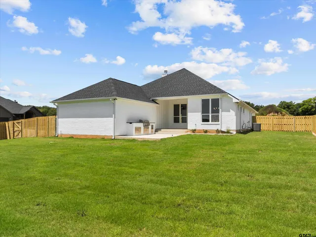 a front view of the house with a garden