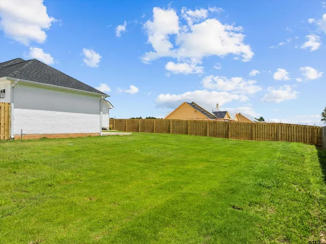 a view of yard with swimming pool and green space