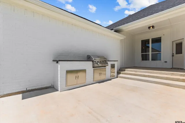 a view of a kitchen with a sink and a refrigerator