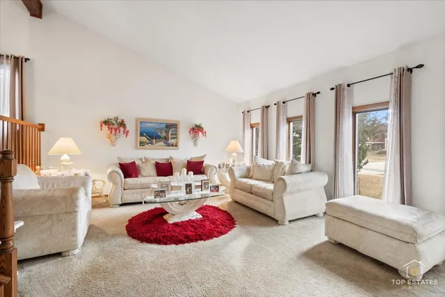 a living room with furniture and a floor to ceiling window