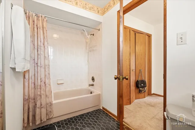 a bathroom with a shower and a bath tub