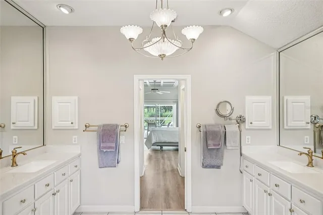 a spacious bathroom with a double vanity sink a mirror a vanity and window