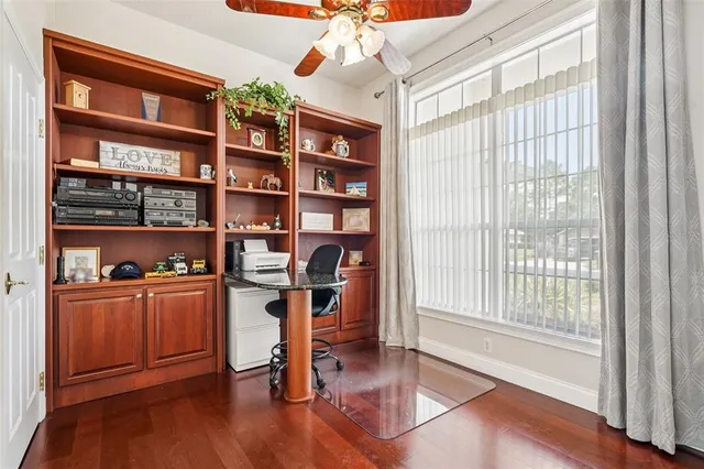 a view of a livingroom with a large window and wooden floor