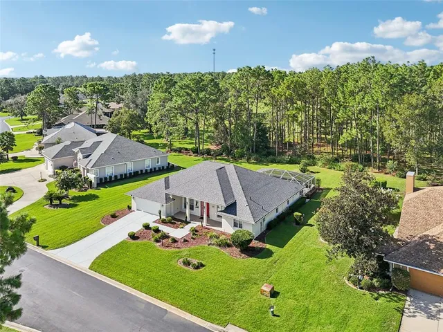 an aerial view of a house with swimming pool and big yard