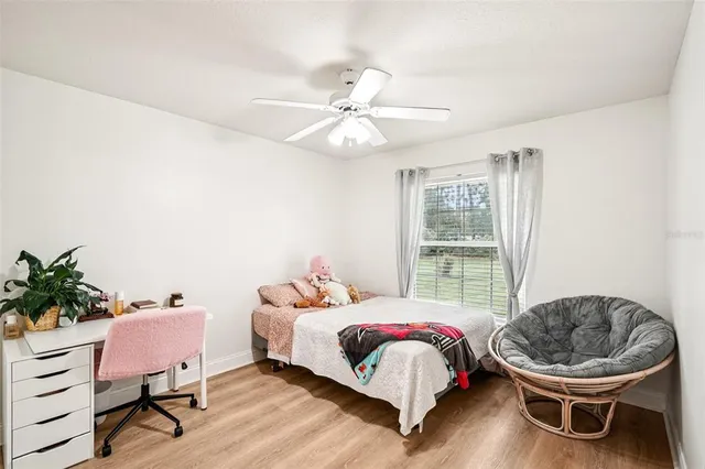 a bedroom with a bed and a chair