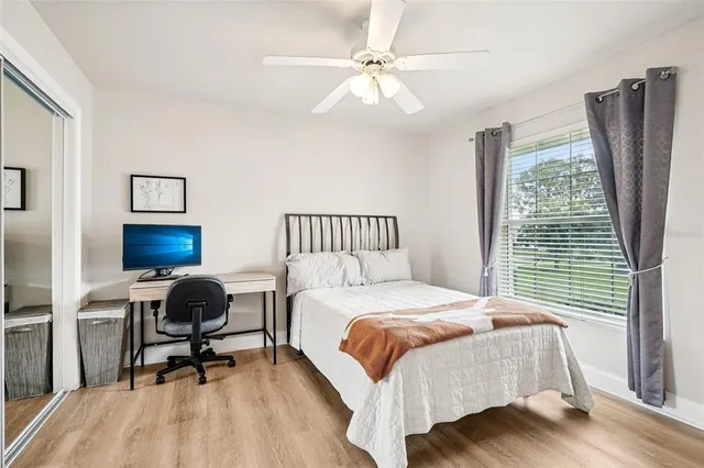 a bedroom with a bed a desk and chair