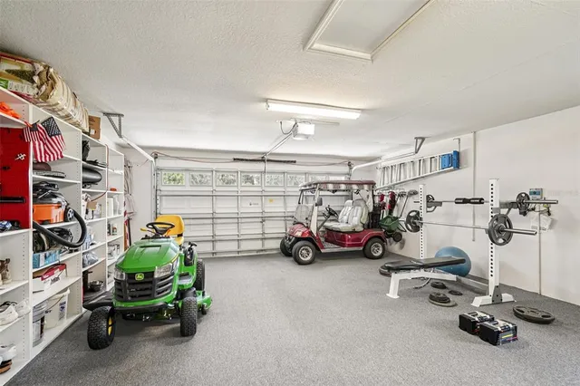 a view of a garage with cars and other equipment