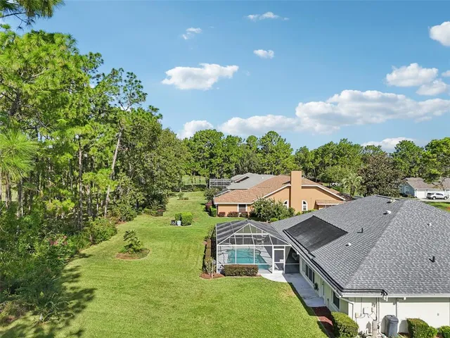 a view of a house with backyard and a garden