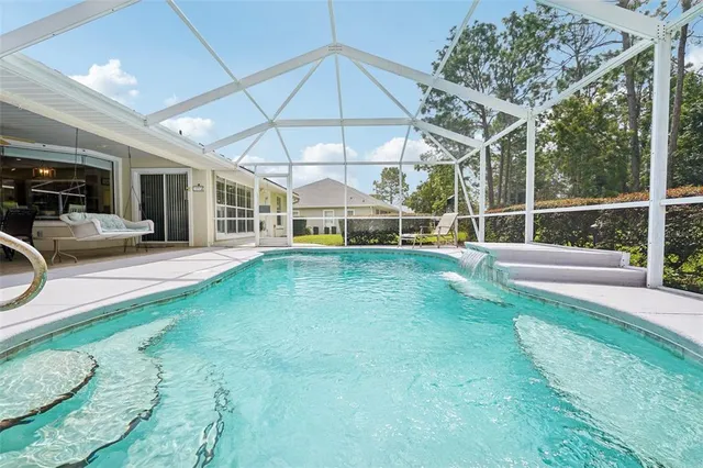 a view of a backyard with a small deck and a garden