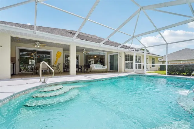 a swimming pool with outdoor seating yard and barbeque oven