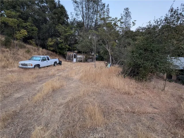 a room with water heater and wooden cabinets