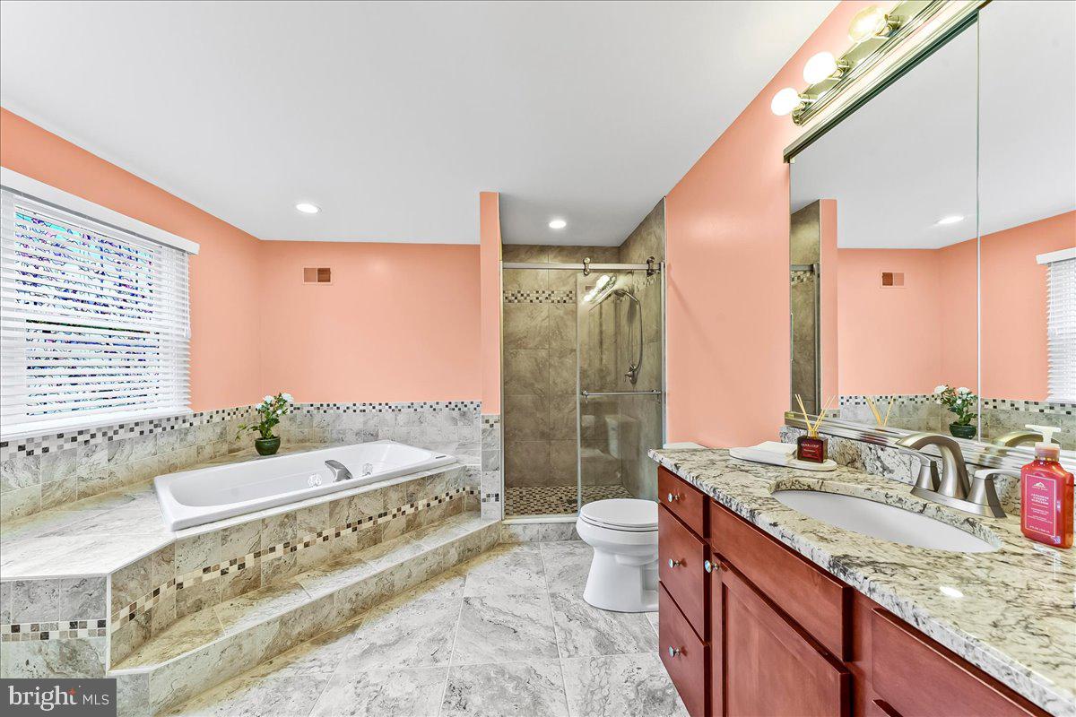 408 Brentford Road Kennett Square, PA 19348 - Photo 24 of 41 a bathroom with a granite countertop sink a toilet a mirror and bathtub