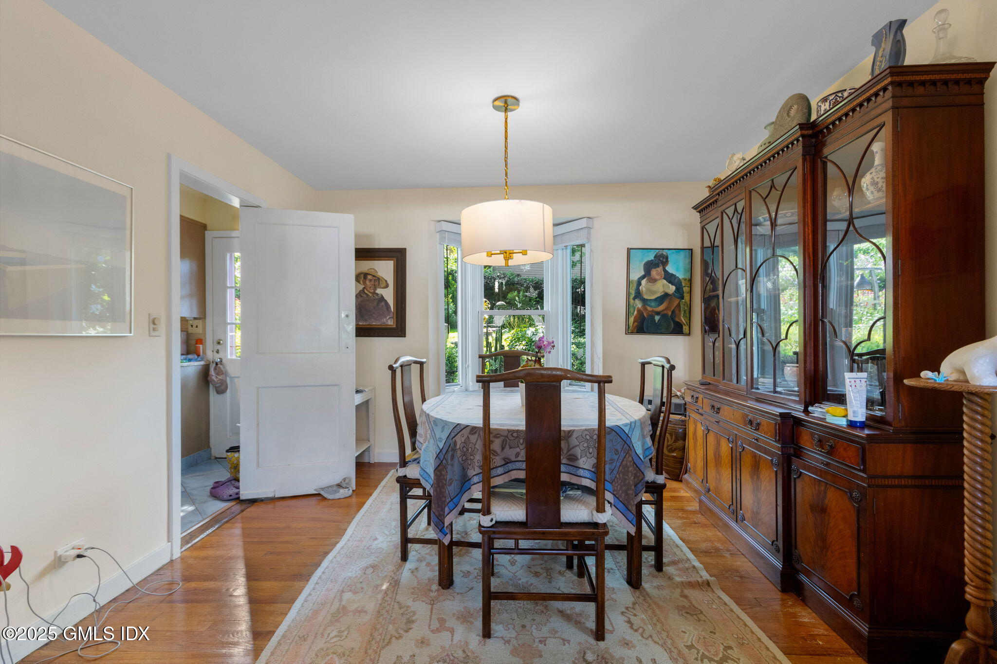 10 Pilgrim Drive Greenwich, CT 06831 - Photo 6 of 18 a dining room with furniture a chandelier and wooden floor