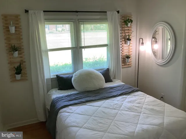 a bedroom with a large bed and a window