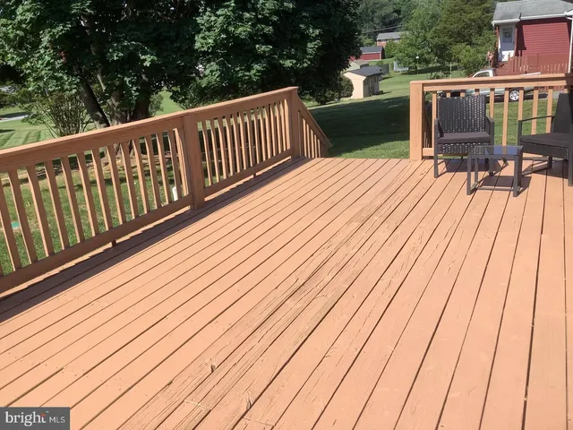 a balcony with wooden floor and outdoor space