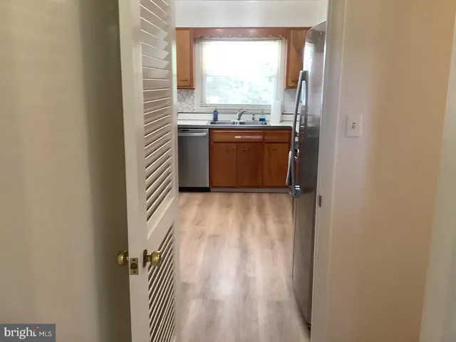 a view of a kitchen with a sink and cabinets