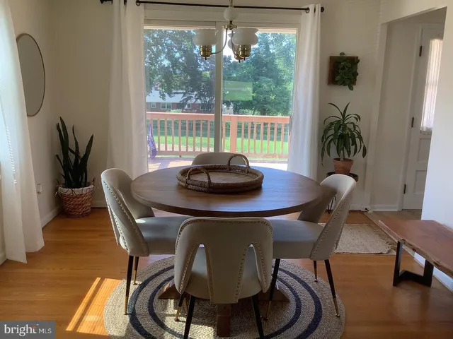 a dining room with furniture and wooden floor