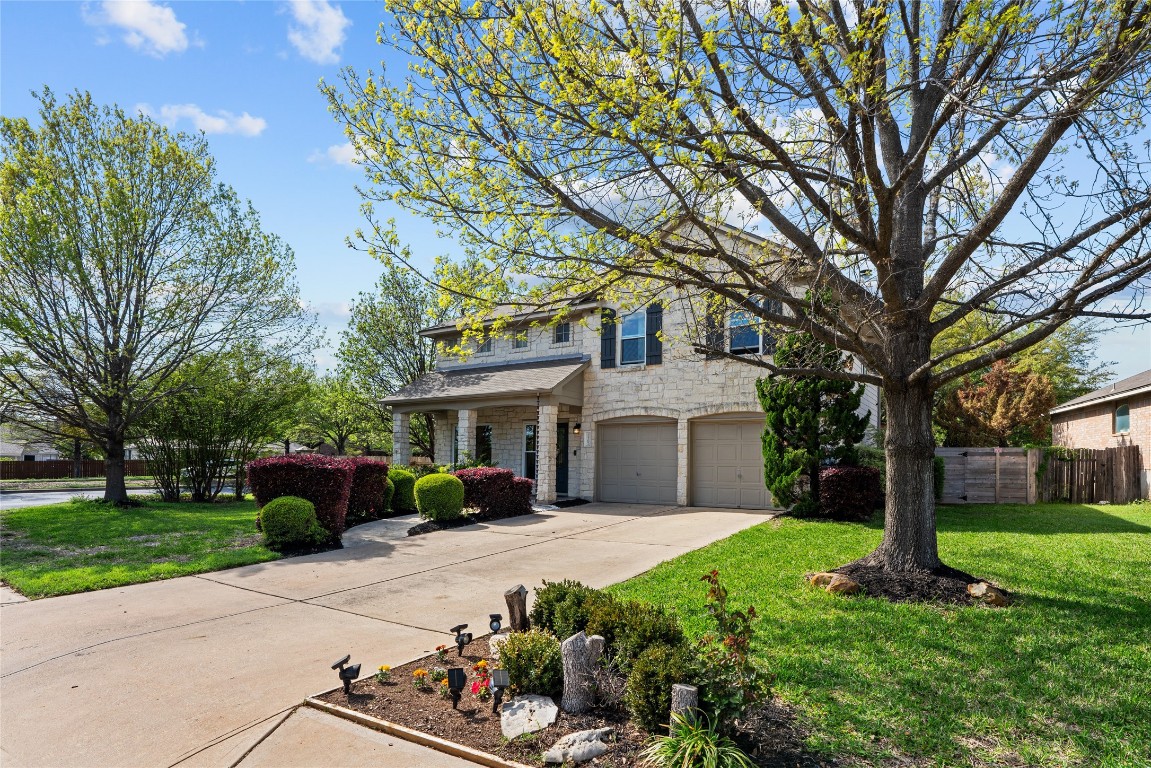 a front view of a house with a garden