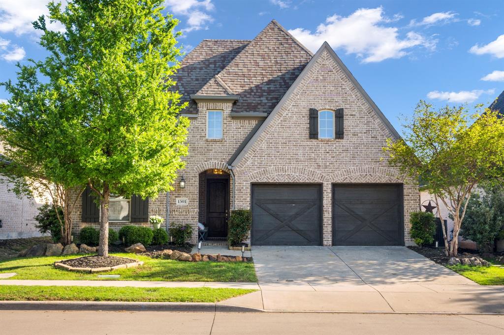 1501 Snowdrop Drive Prosper, TX 75078 - Photo 1 of 27 a front view of a house with garden
