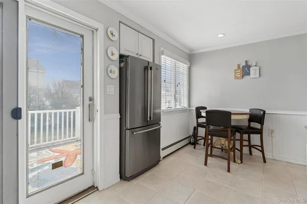 a dining room with furniture and a window