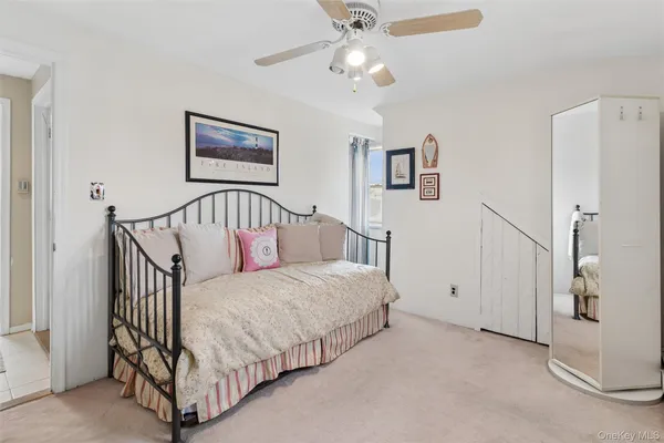 a spacious bedroom with a bed and a chandelier