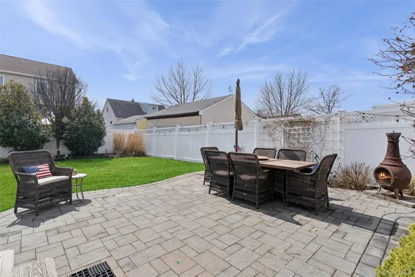 a view of a house with backyard and sitting area