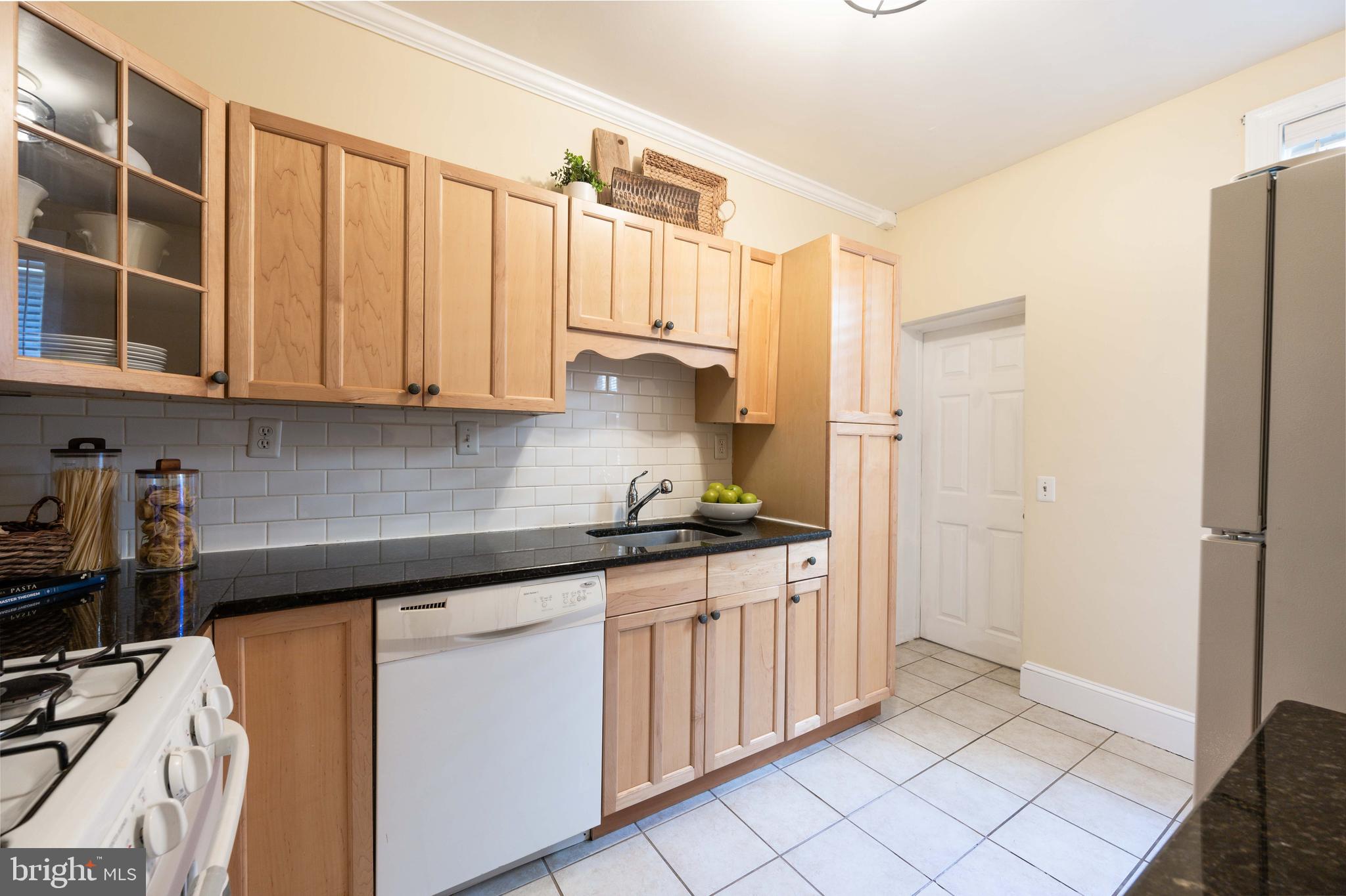 3 East Ostend Street Baltimore, MD 21230 - Photo 15 of 25 a kitchen with stainless steel appliances granite countertop a refrigerator sink and cabinets