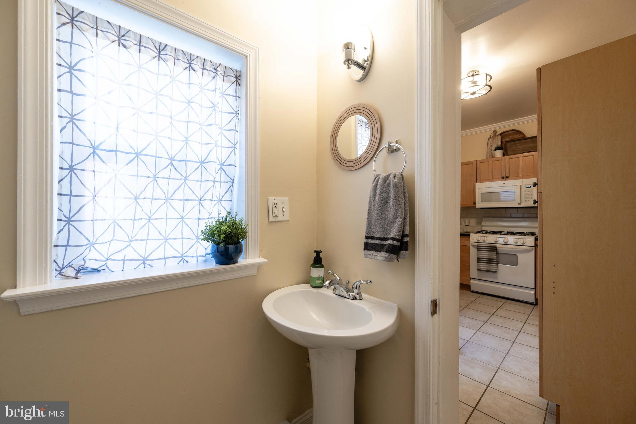 3 East Ostend Street Baltimore, MD 21230 - Photo 17 of 25 a bathroom with a sink and a mirror