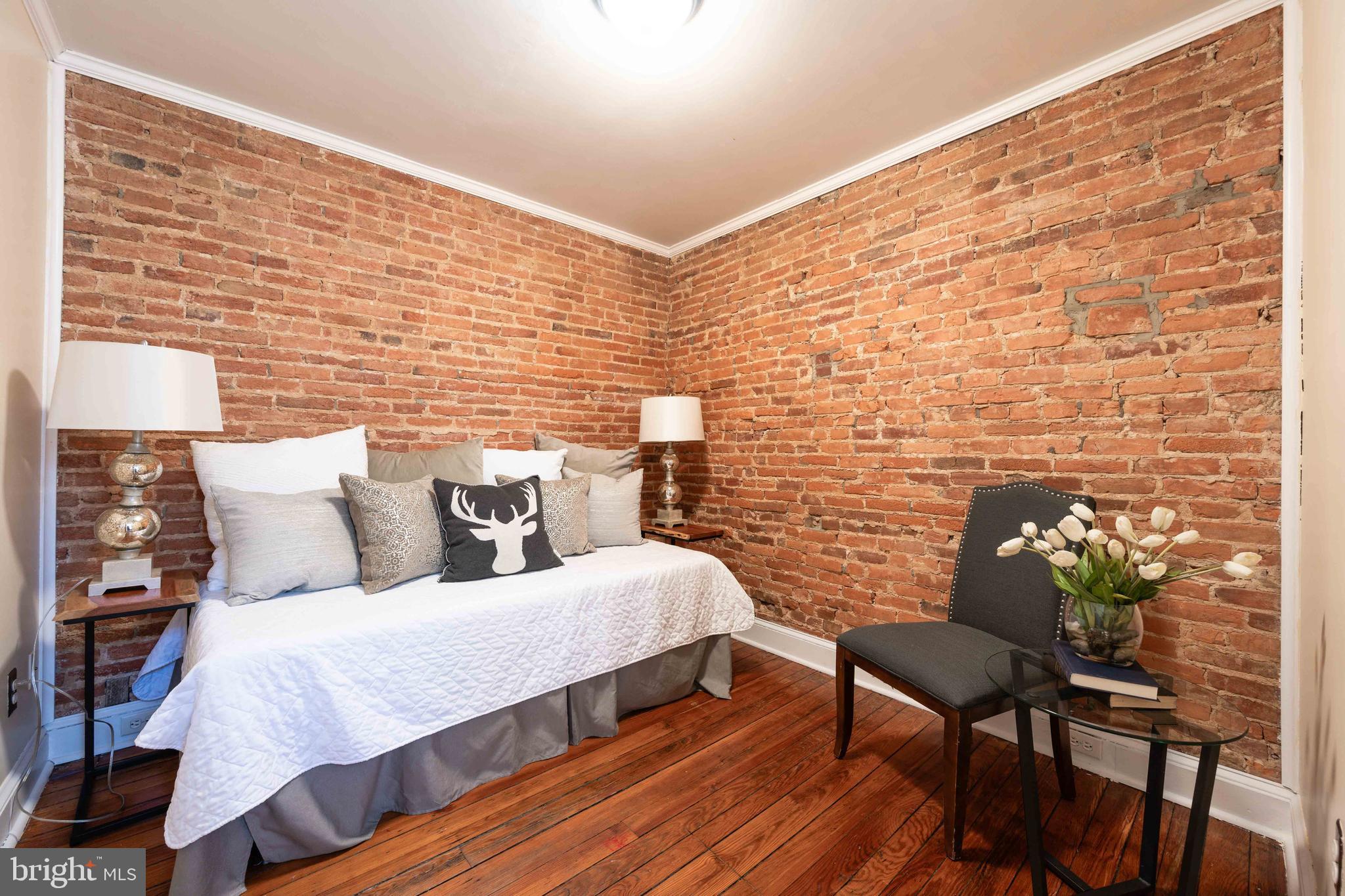 3 East Ostend Street Baltimore, MD 21230 - Photo 23 of 25 a bed room with a bed chair and a wall painting
