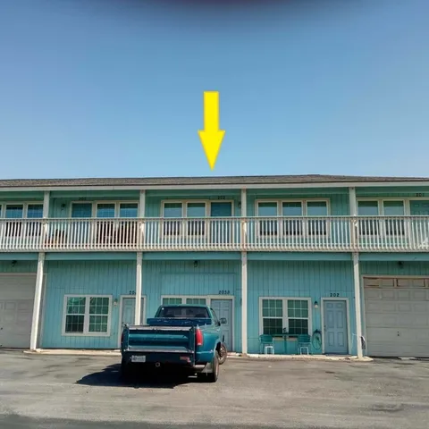 a front view of a building with parking space and windows