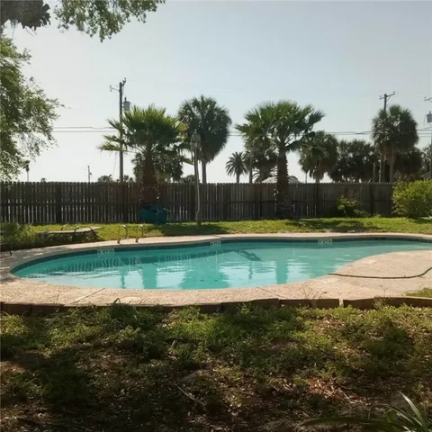 a view of a swimming pool with an outdoor seating yard and ocean view