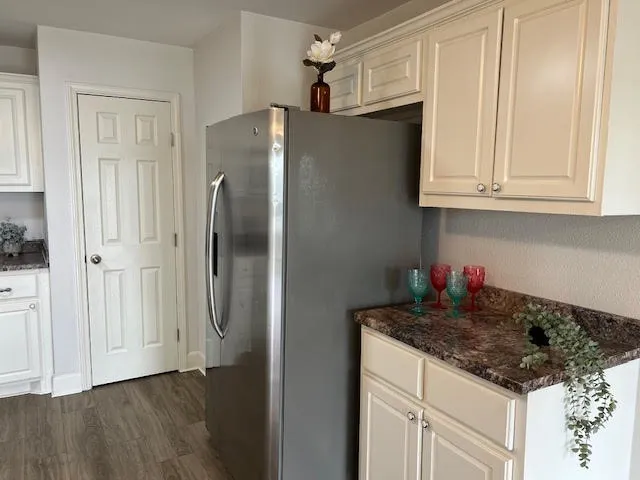 a kitchen with stainless steel appliances granite countertop a refrigerator sink and cabinets