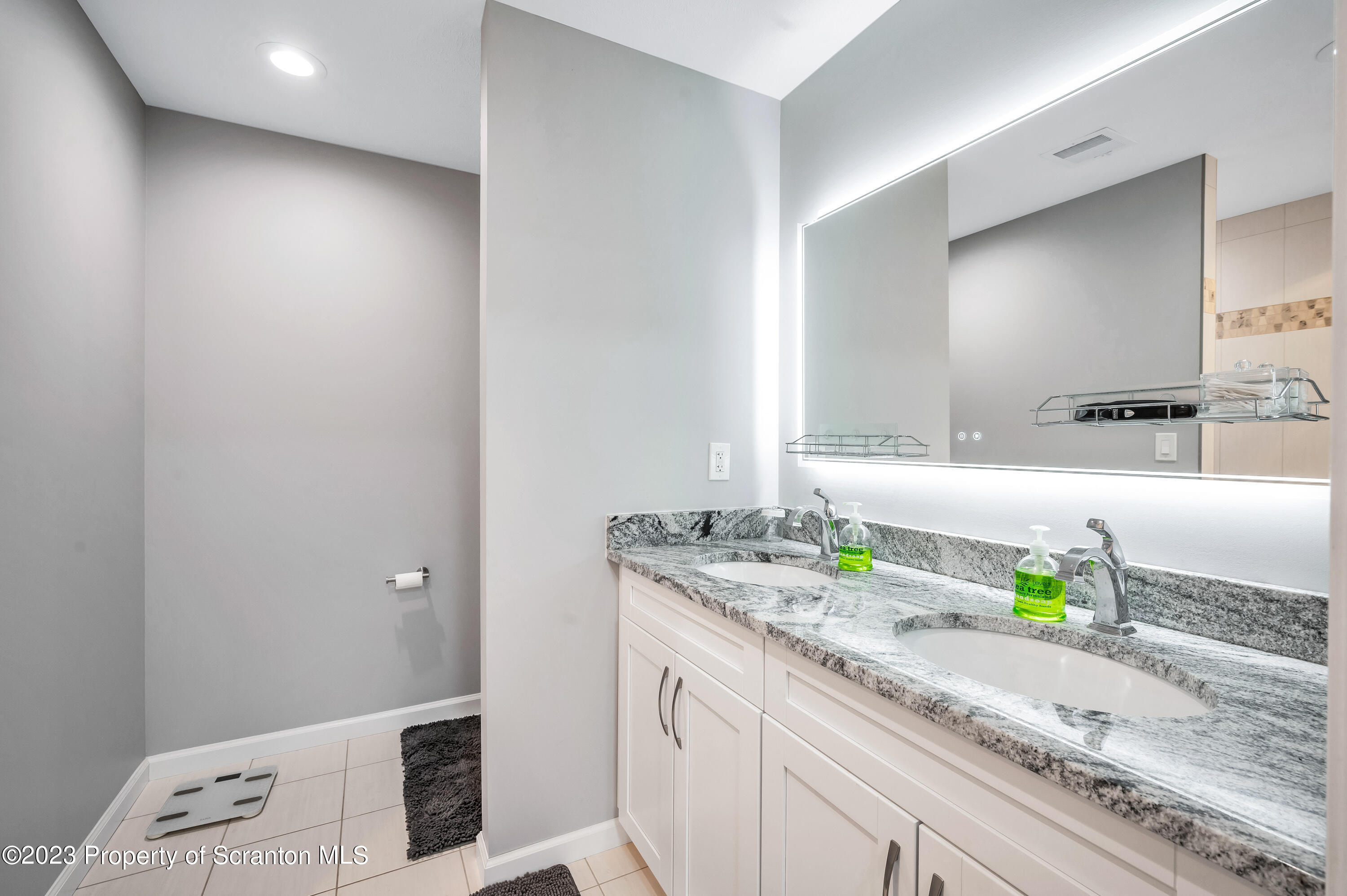171 Golden Gate Circle Circle Archbald, PA 18403 - Photo 24 of 38 a bathroom with a granite countertop sink and a mirror