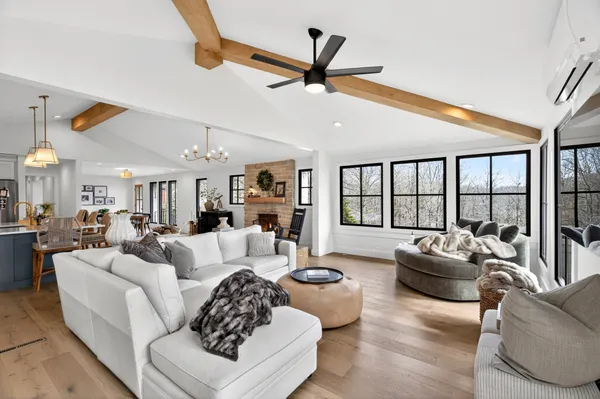 a living room with furniture ceiling fan and a rug