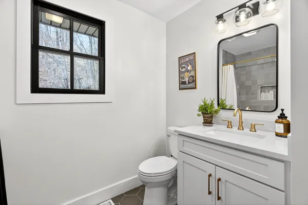 a bathroom with a toilet sink and mirror